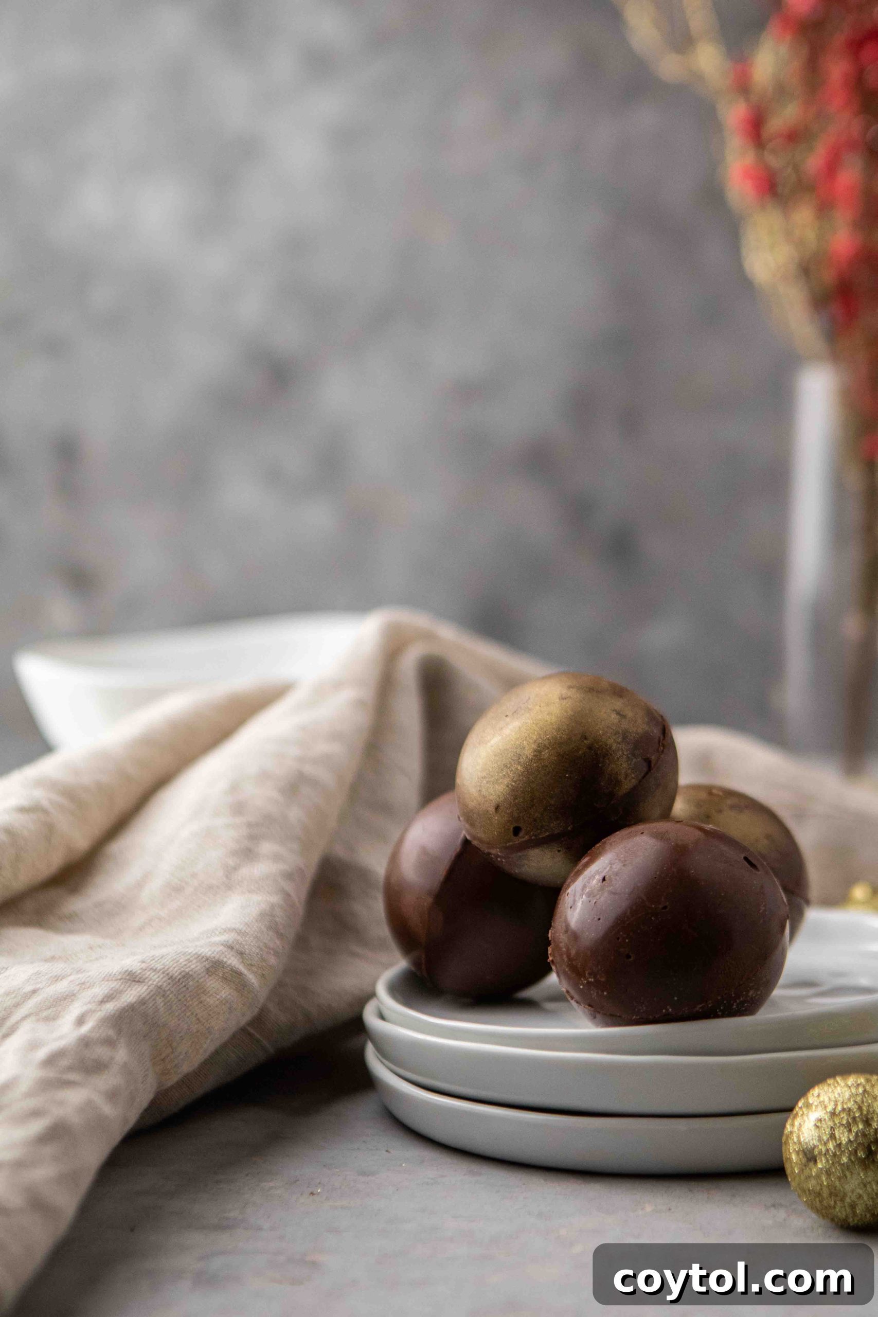 Several hot chocolate bombs arranged on a plate