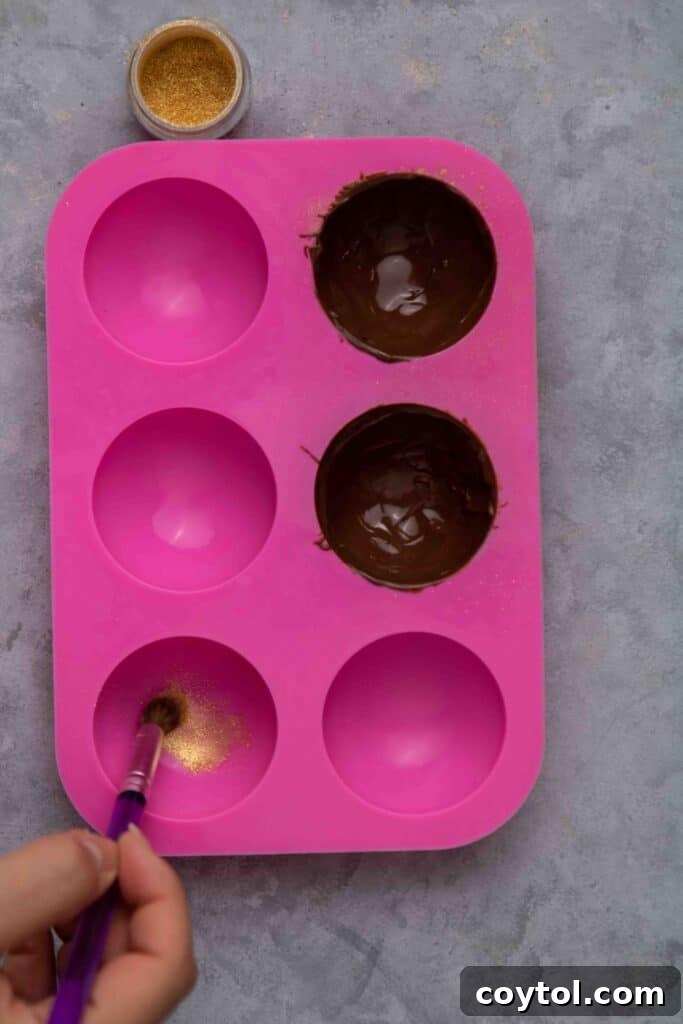 Spoon coating chocolate inside a silicone mold