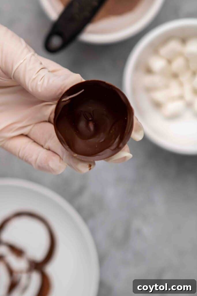 Hot chocolate bomb halves being removed from mold