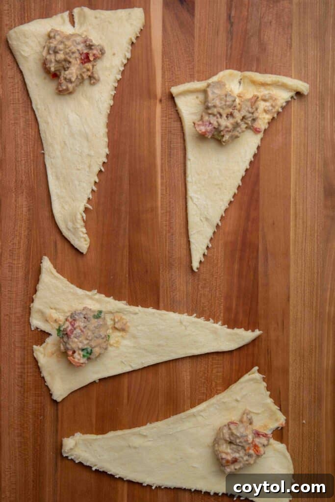 Zesty Rotel Beef and Cheese Crescents 4 Step 1: Unroll crescent dough and make slits