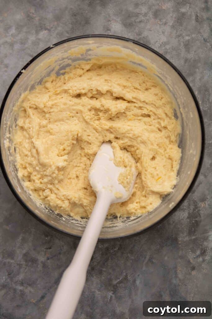 Another view of muffin batter in a tin