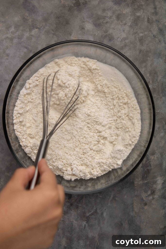 Step-by-step: Whisking wet ingredients for cranberry orange muffins