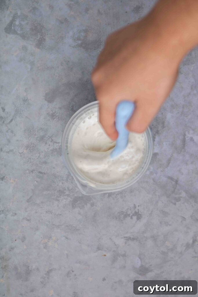 Stirring the heavy cream with the half and half