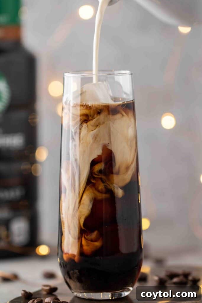 Pouring-sweet-cream-over-cold-brew