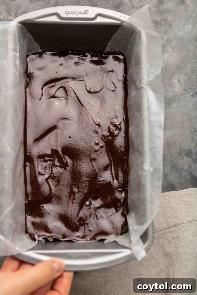 How to make hazelnut chocolate bites: Pouring base into loaf pan