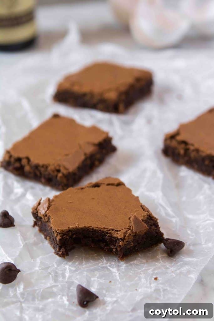 Homemade brownies without cocoa powder, stacked to show their thick, chewy texture.