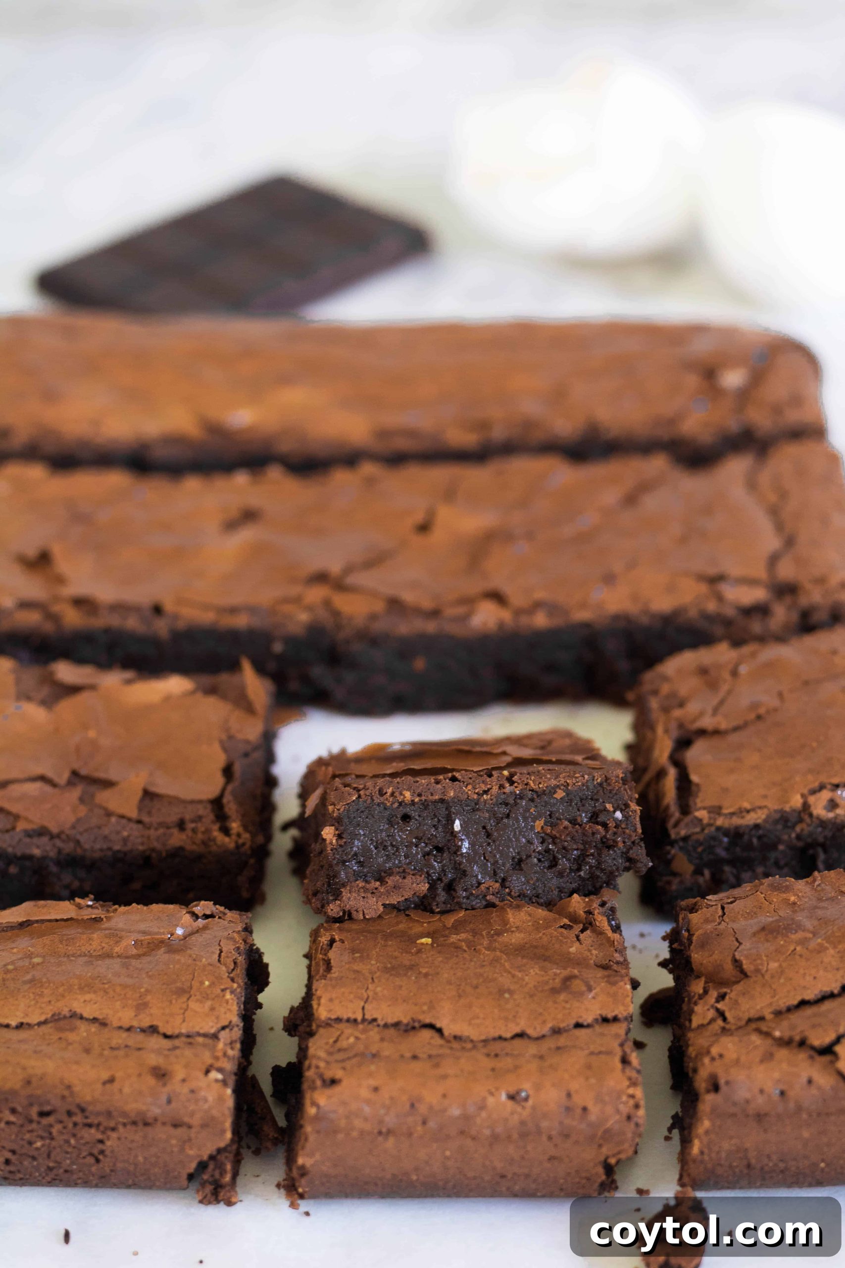Rich brownies with a dense, gooey center and shiny, crackled top.