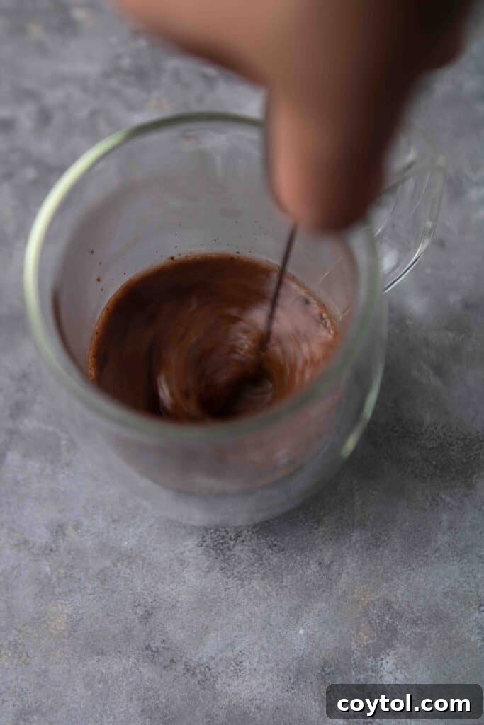 Guilt-Free 3-Ingredient Hazelnut Hot Chocolate 6 Adding hazelnut milk to cocoa paste