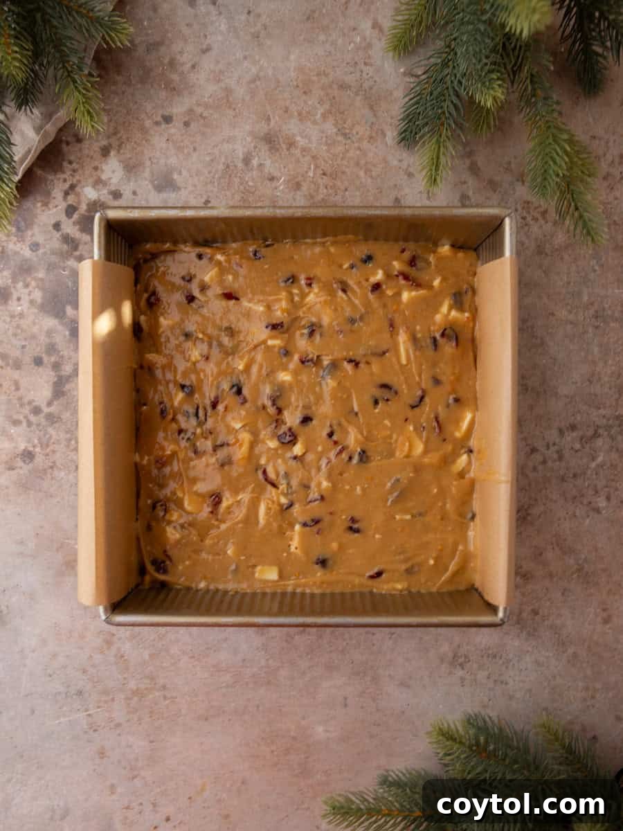 Homemade Cranberry Bliss Bars Surpassing Starbucks 8 Cranberry blondie batter spread evenly in a parchment-lined square baking pan.