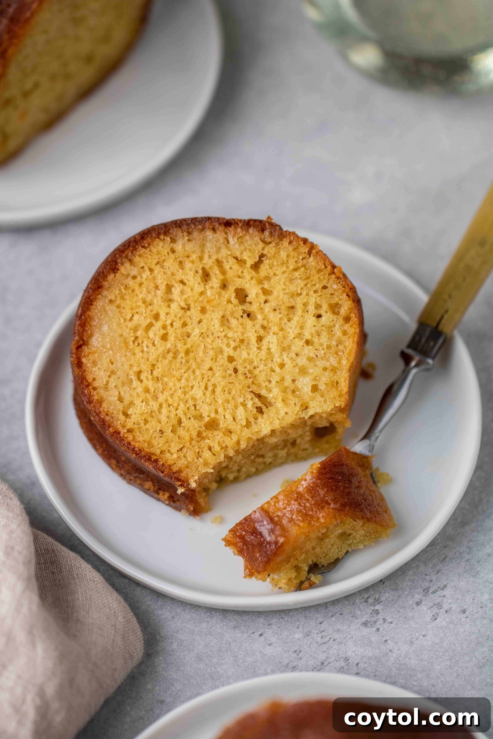 The Ultimate Not-Too-Sweet Bundt Cake 6 Taking a bite of the doctored up yellow cake mix bundt cake, showing its moist texture