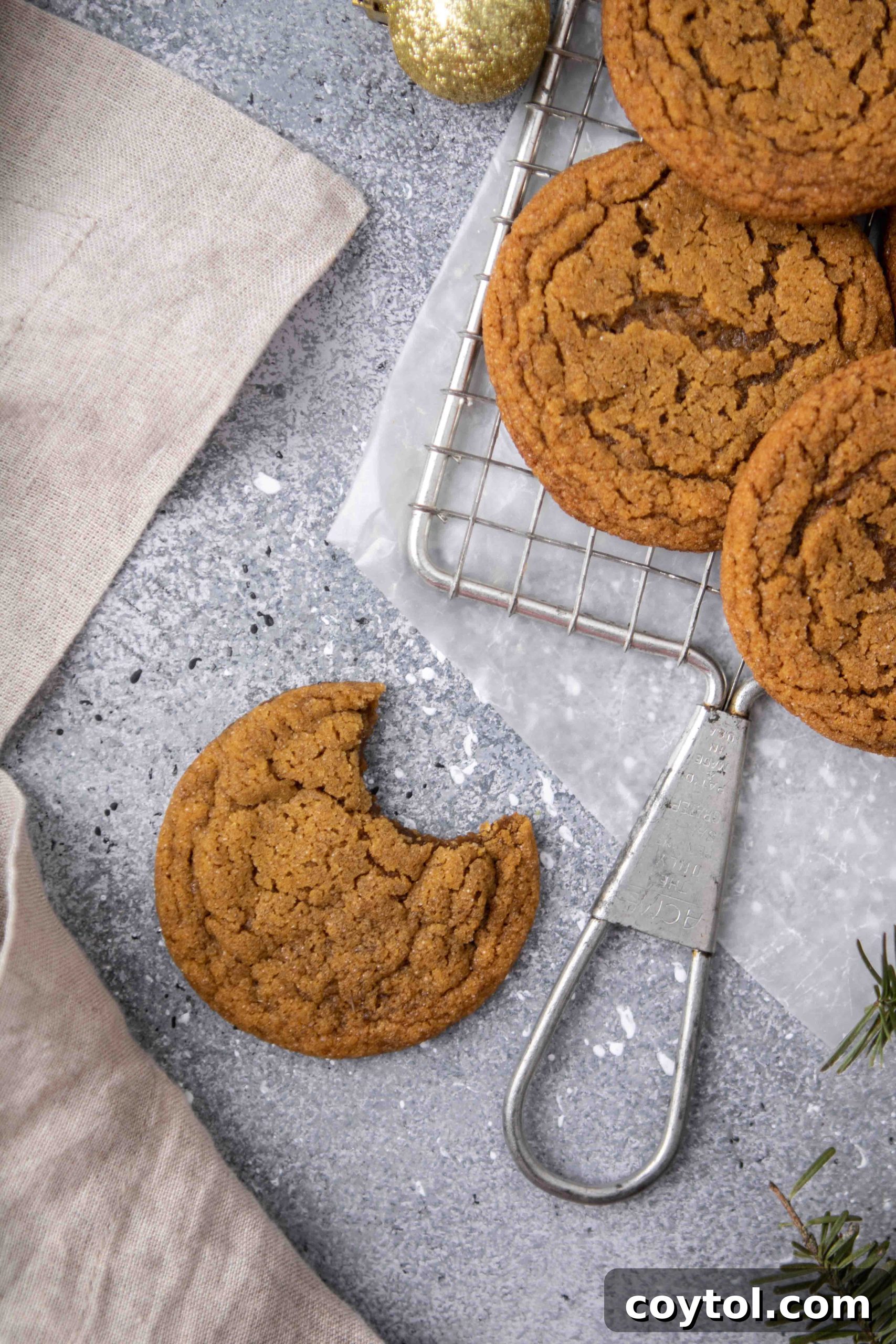 Overhead shot of a full batch of ginger molasses cookies on a cooling rack