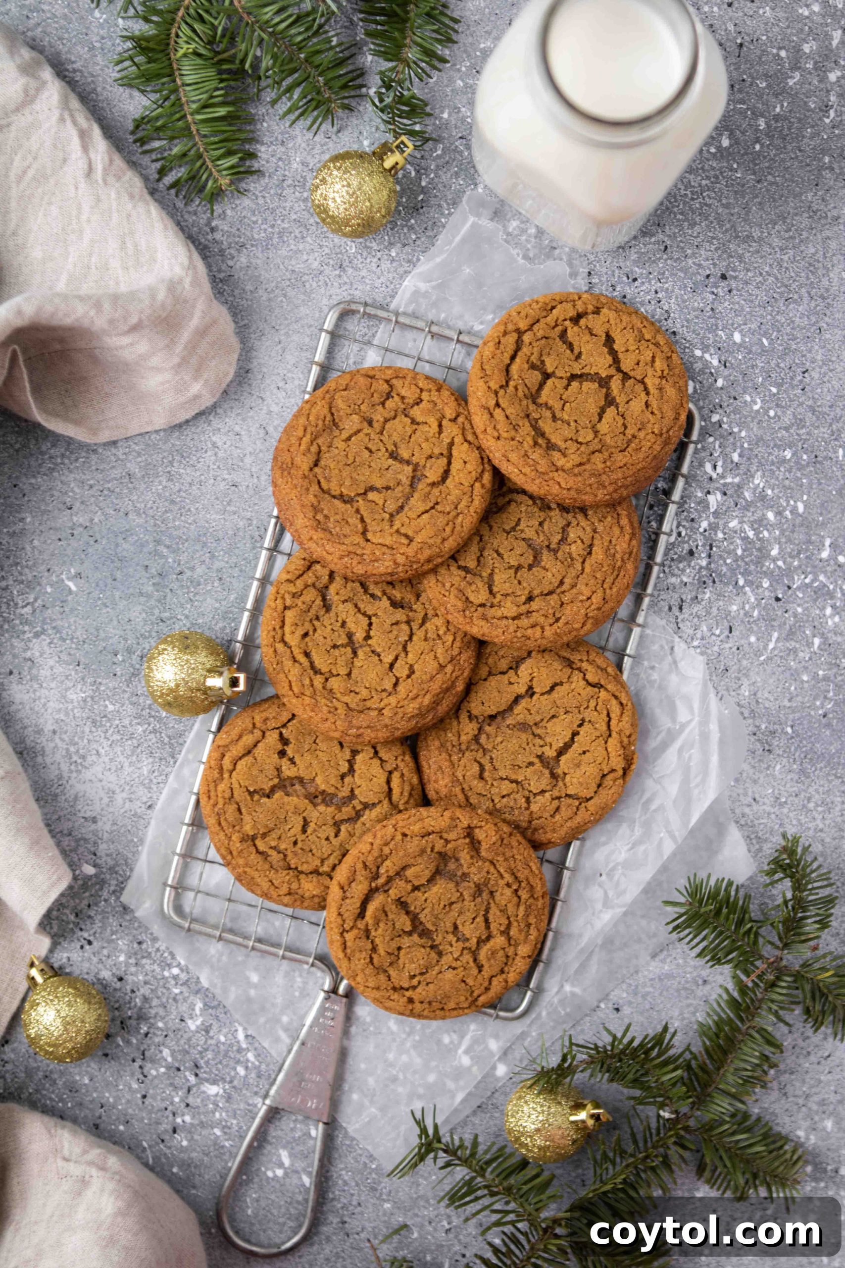Overhead photography of perfectly baked ginger molasses cookies arranged on a cooling rack