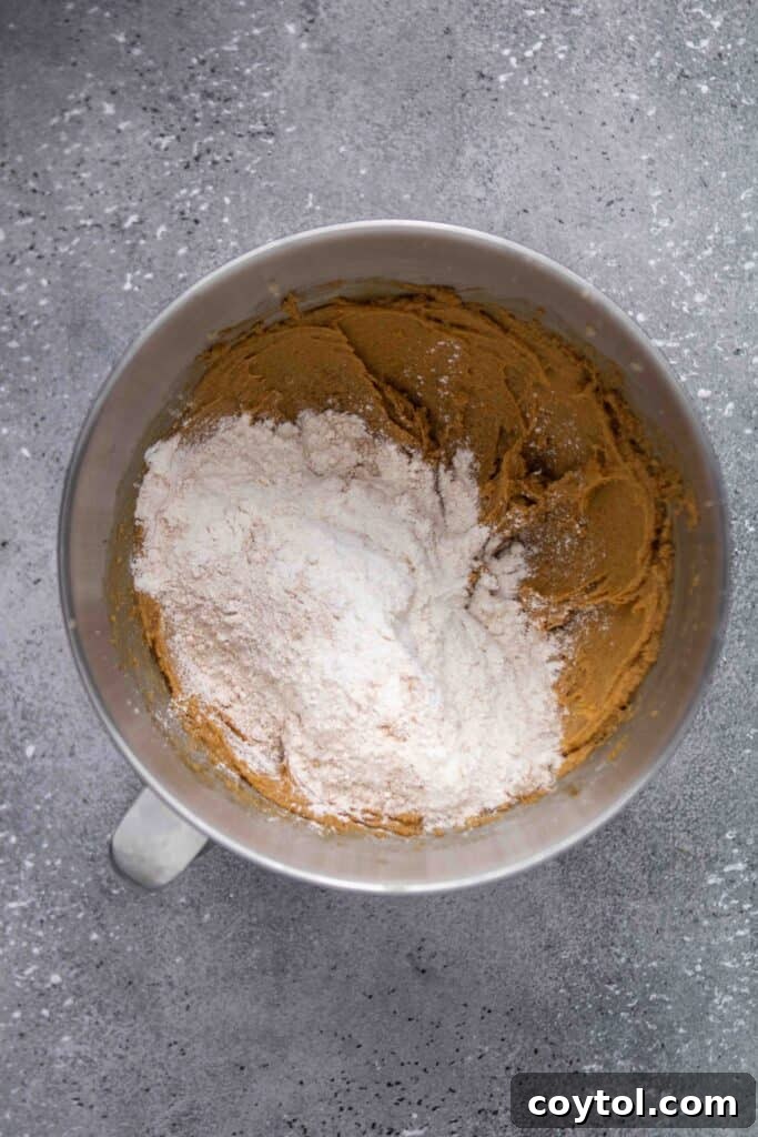 Step-by-step image of rolling cookie dough in sugar