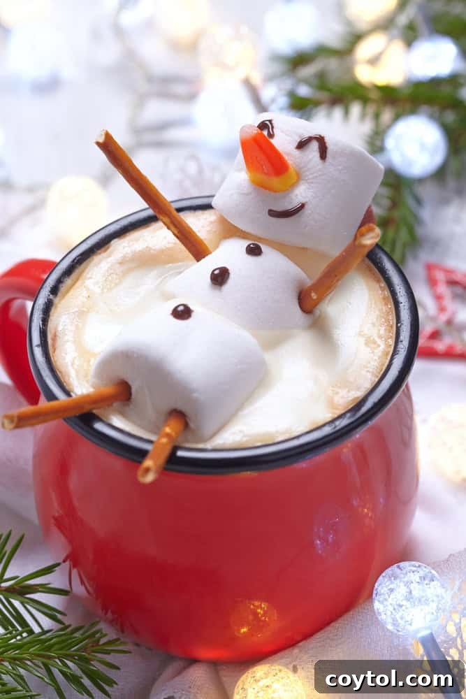Cute snowman hot chocolate to make with kids, featuring marshmallow snowmen.