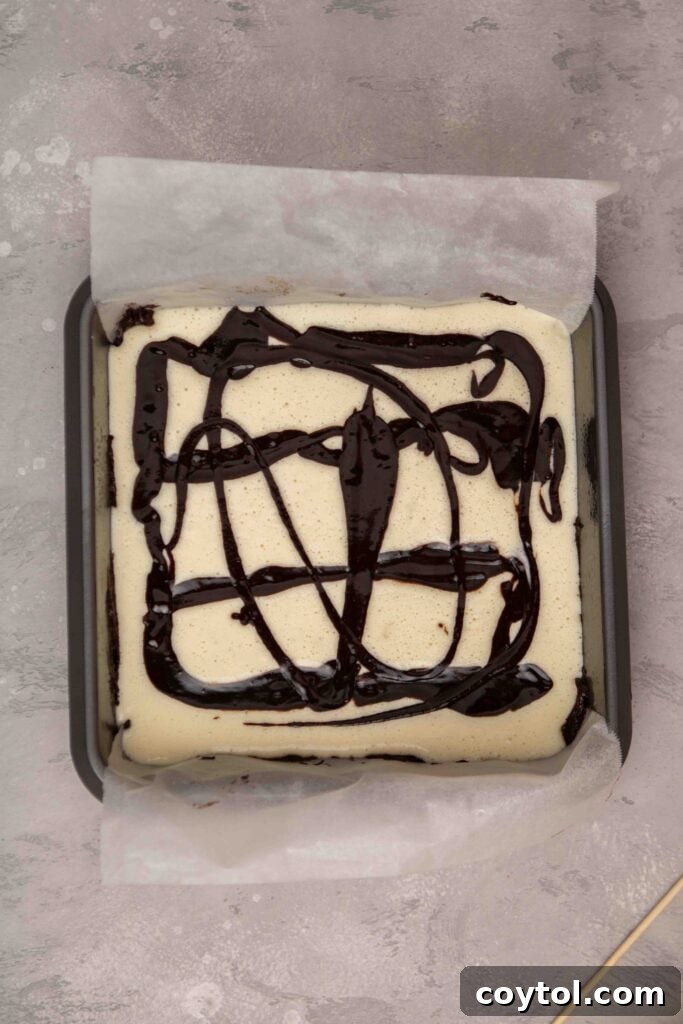 Decadent Fudgy Cheesecake Brownies 12 Pouring thinned out brownie batter over the cream cheese layer