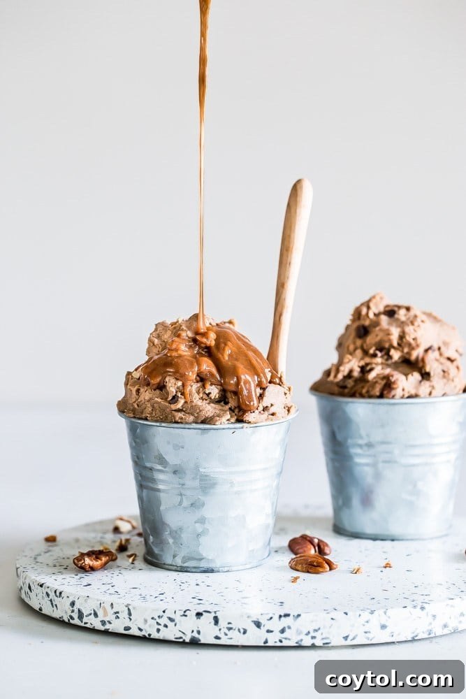 Mini buckets filled with delicious pumpkin caramel pecan cookie dough, ready for scooping and enjoying.