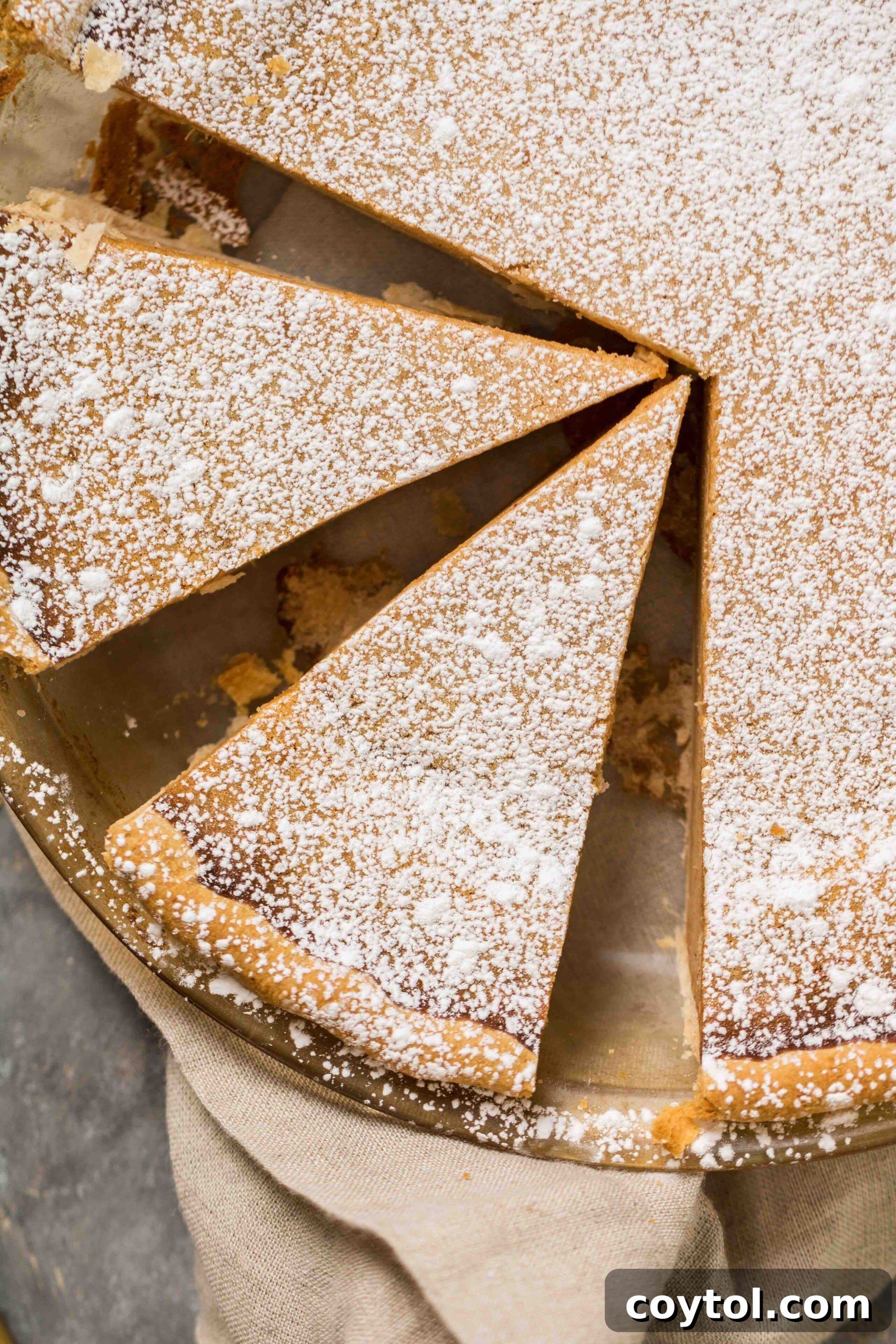 Close-up of freshly cut slices of yam pie on a serving dish, highlighting the smooth filling.