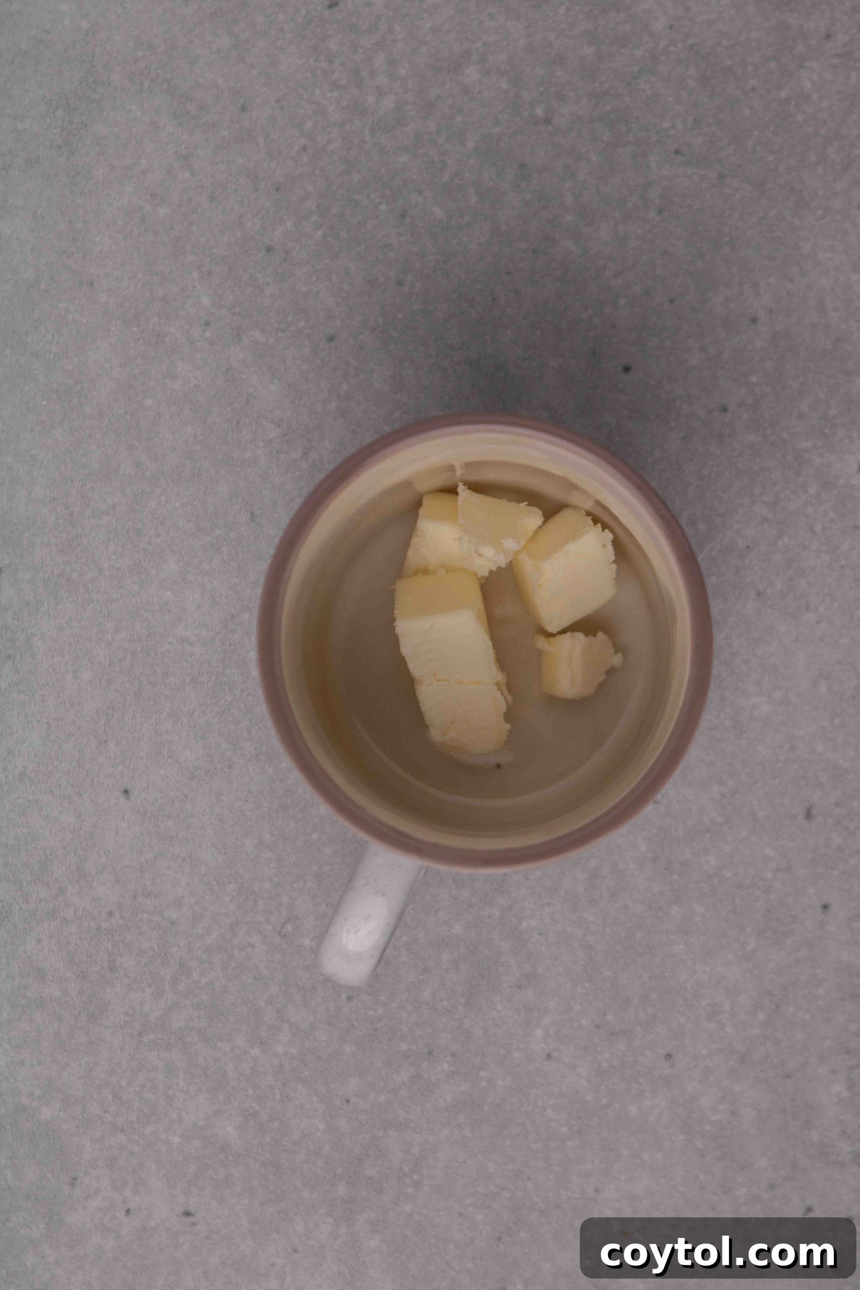 Step-by-step image of melting butter for mug cookie