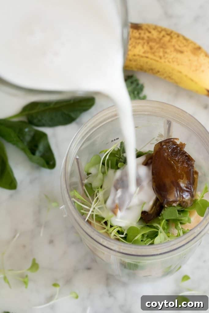 Pouring the coconut milk in the blender to make a healthy green smoothie