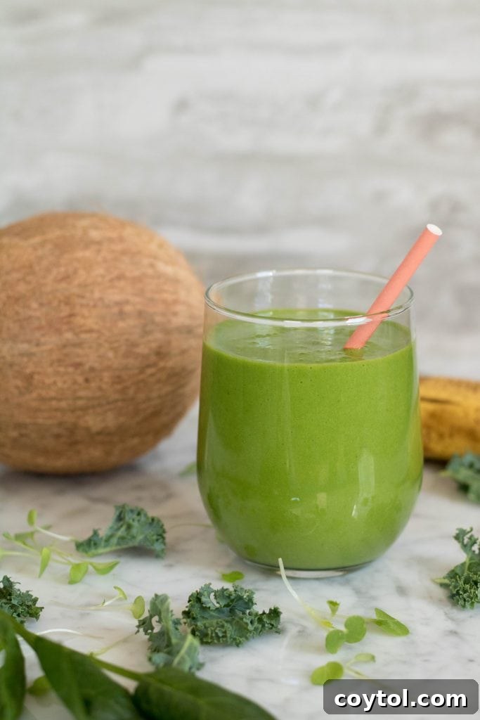 Kale and Spinach Smoothie photo with a coconut in the back
