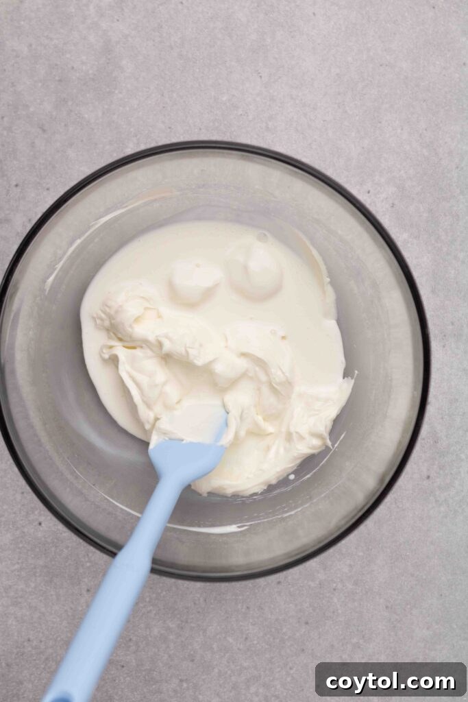 Step-by-step image 1: Mixing cream cheese, heavy cream, and sour cream for mini burnt Basque cheesecake.