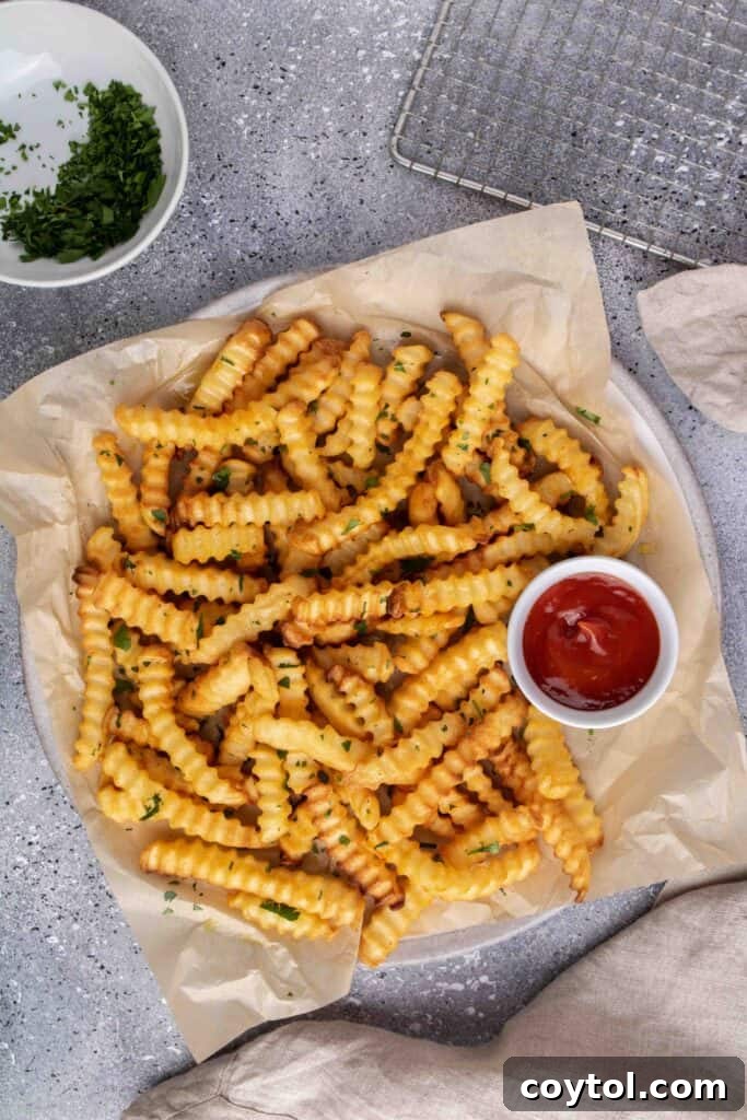 Crispy Air Fryer Fries with Fiery Ketchup 8 Shaking the air fryer basket to ensure even cooking of French fries