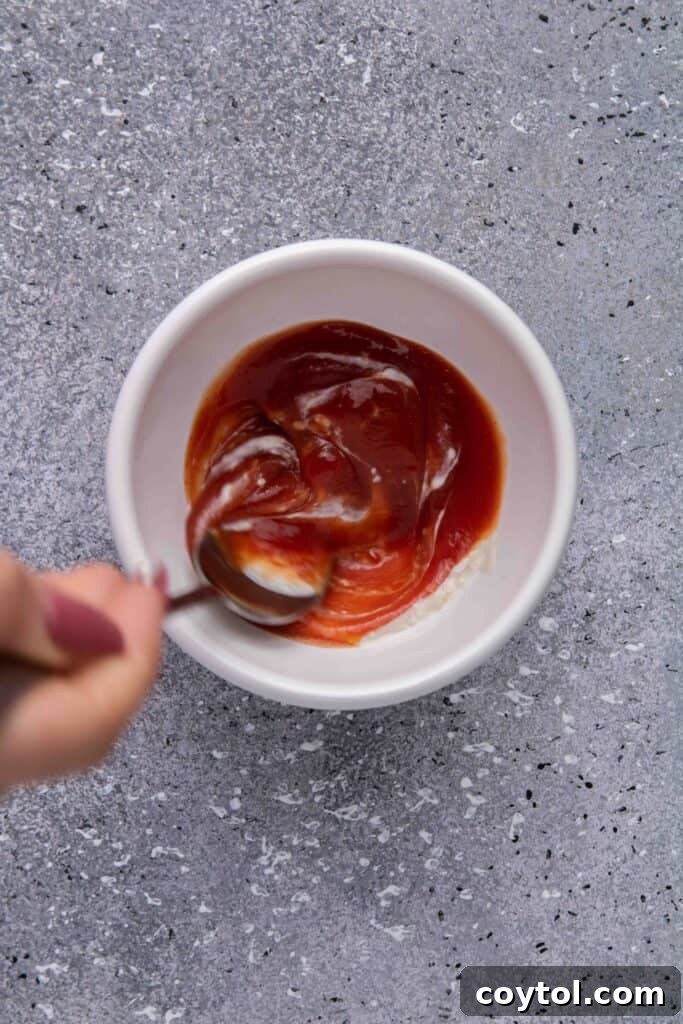 Crispy Air Fryer Fries with Fiery Ketchup 9 Mixing ketchup and horseradish in a small bowl to make spicy dip