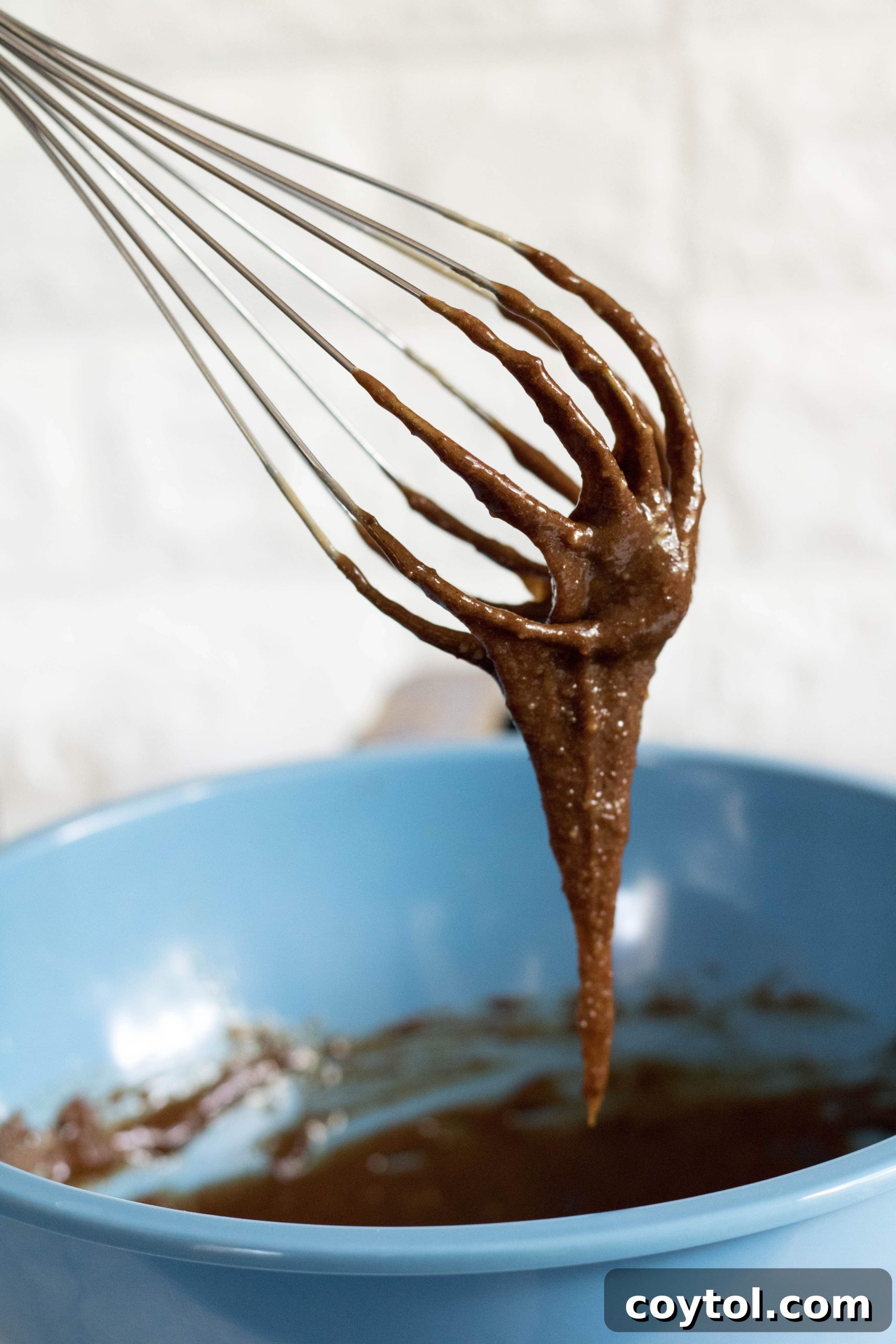 Close-up of the smoothly mixed wet ingredients for tahini sesame cookies.