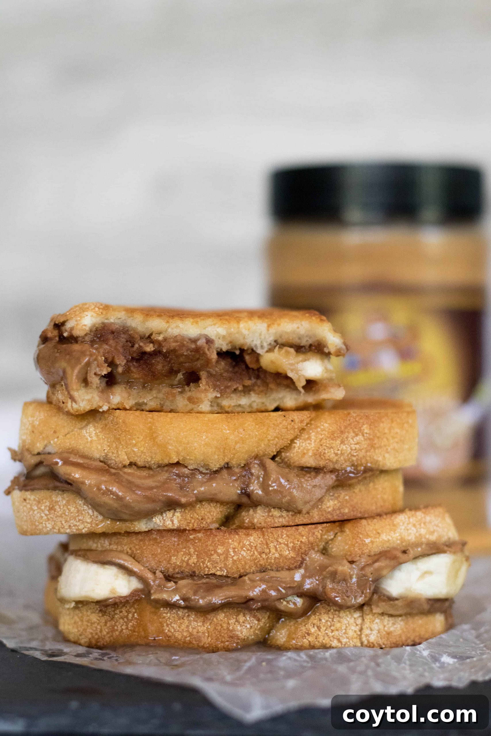 Grilled Peanut Butter Banana Sandwich sliced in half, revealing creamy peanut butter and soft banana