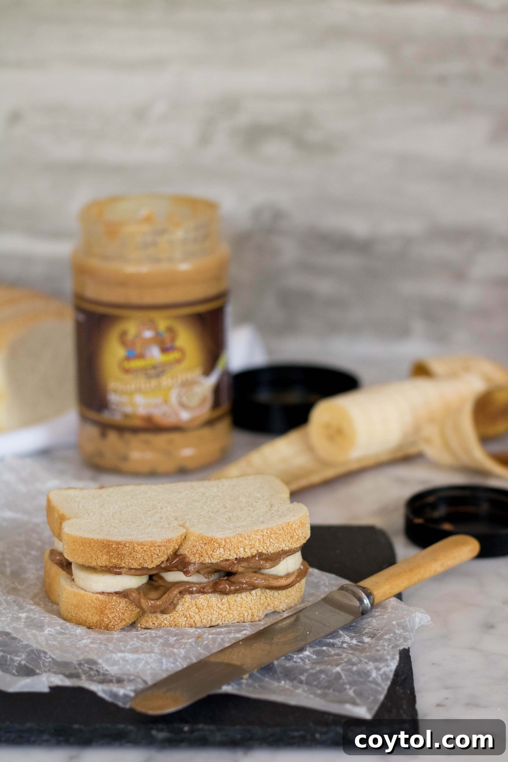 Placing banana slices onto the peanut buttered bread