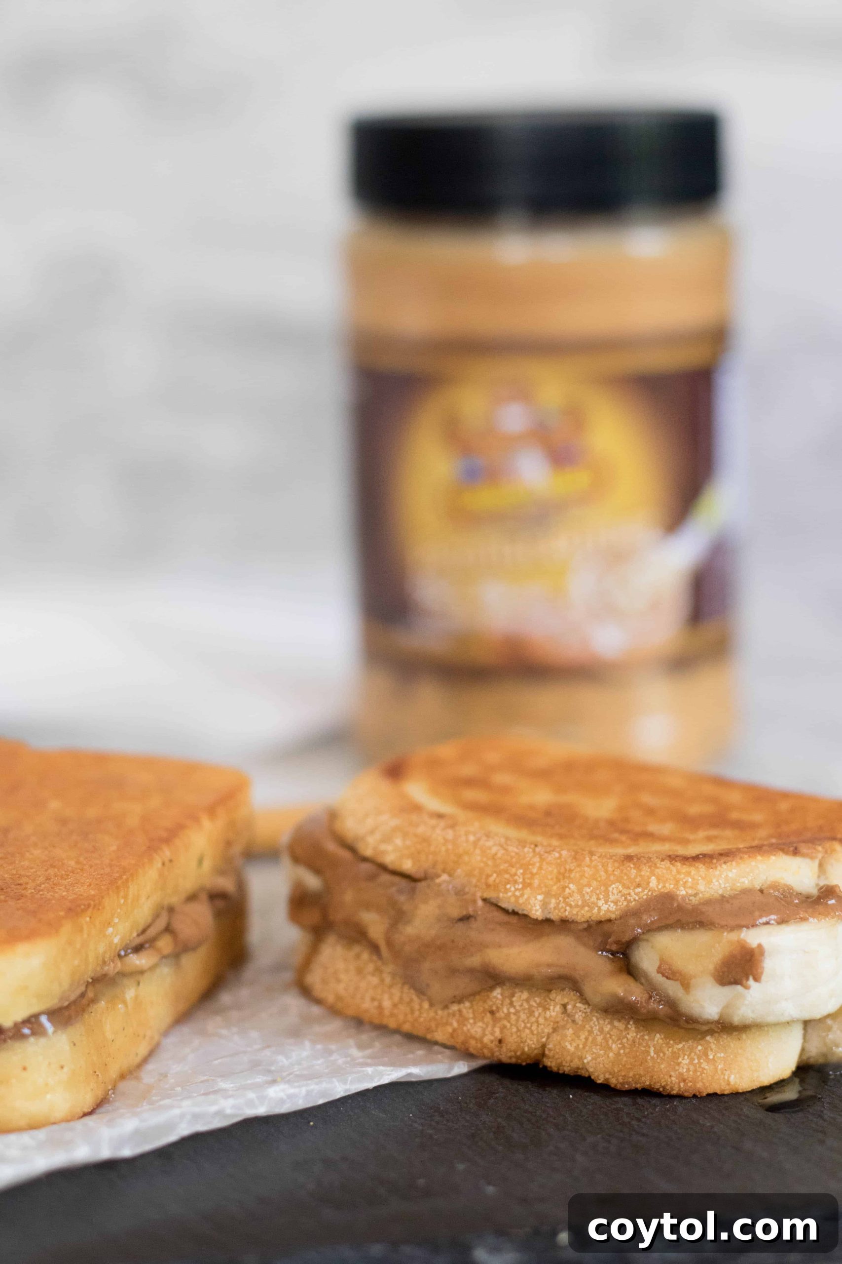 Delicious peanut butter oozing out of a grilled banana peanut butter sandwich