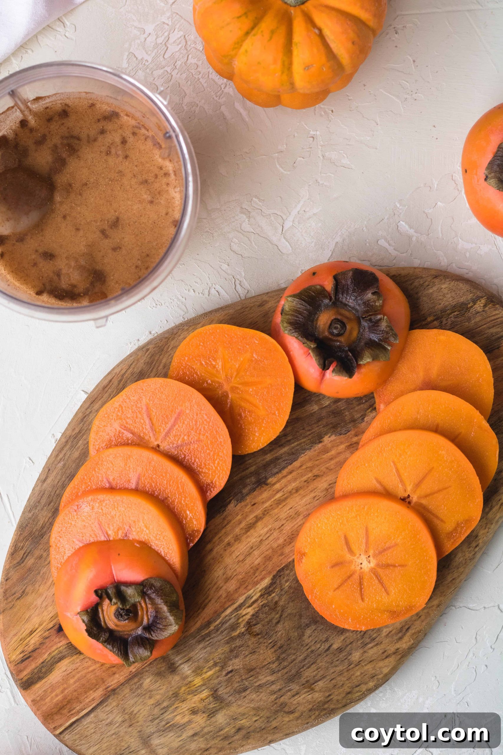 Beautifully sliced Fuyu persimmons arranged on a cutting board, ready for various culinary uses.