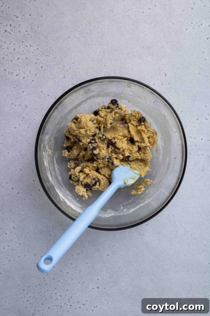 Close-up of freshly mixed chocolate chip cookie dough in a bowl.