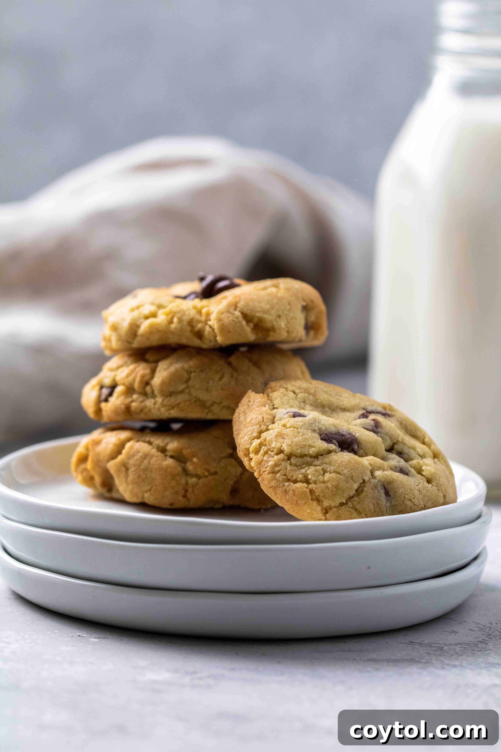 A perfectly stacked pile of freshly air-fried chocolate chip cookies, indicating their soft and chewy texture.