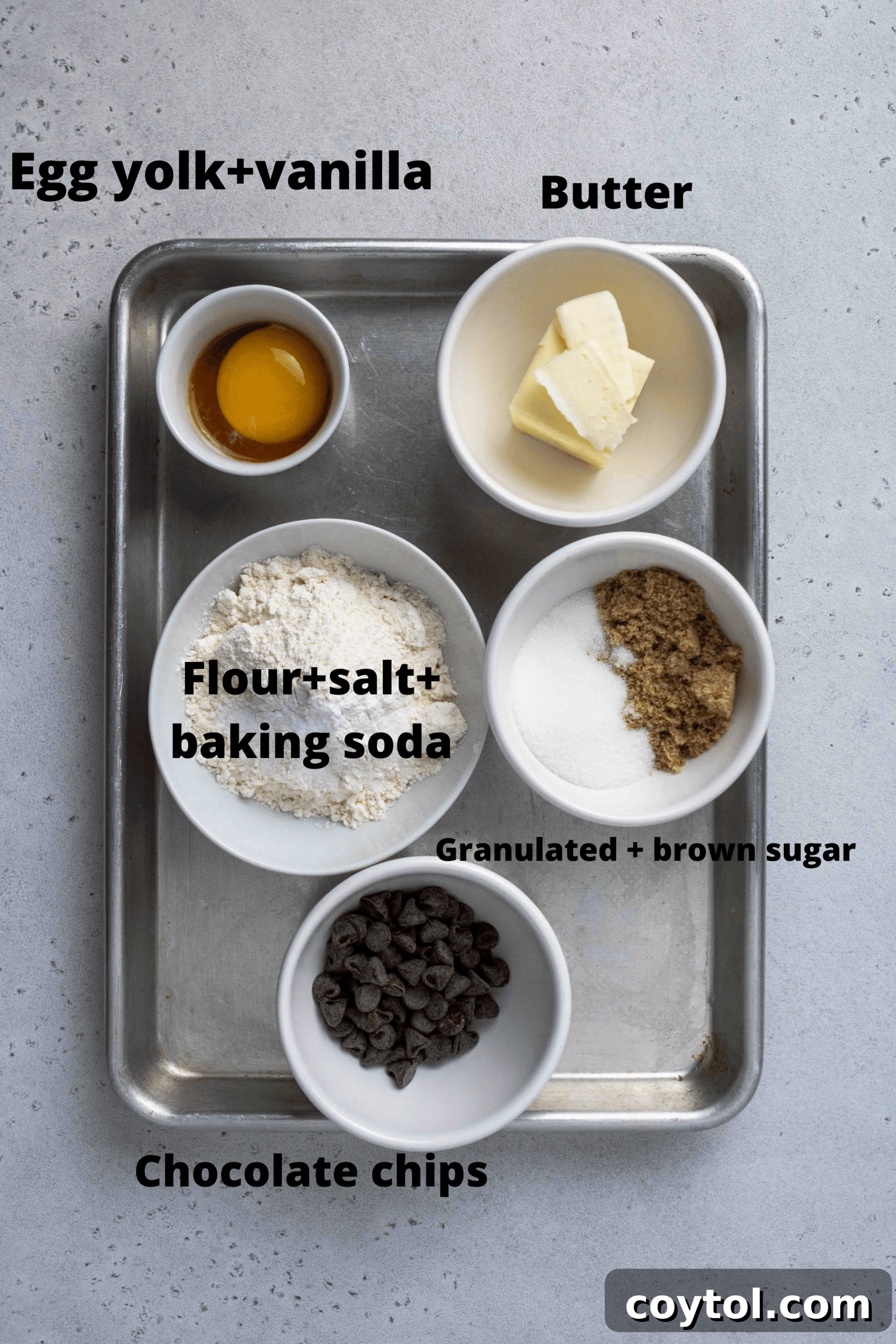 Assorted ingredients for chocolate chip cookies laid out on a kitchen counter, ready for preparation.