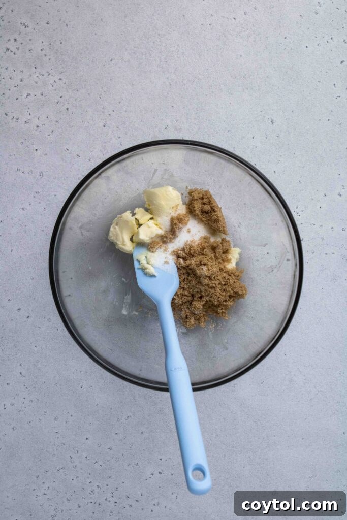 Creamed butter and sugar being mixed in a bowl for chocolate chip cookies.