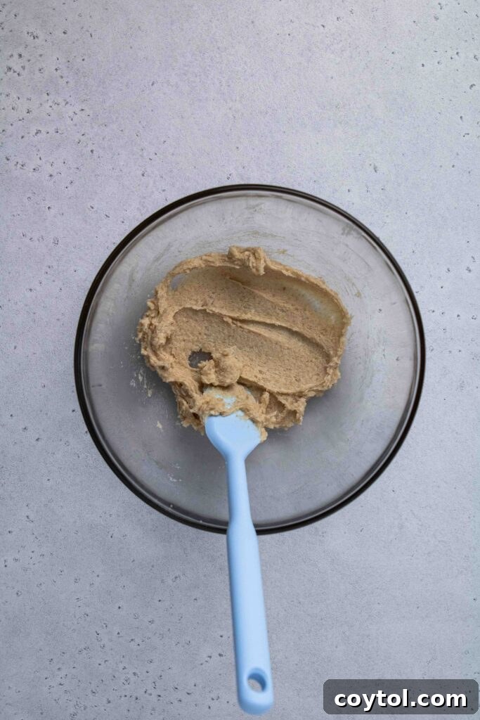 Further creaming of butter and sugar in a bowl, showcasing the light and fluffy texture.