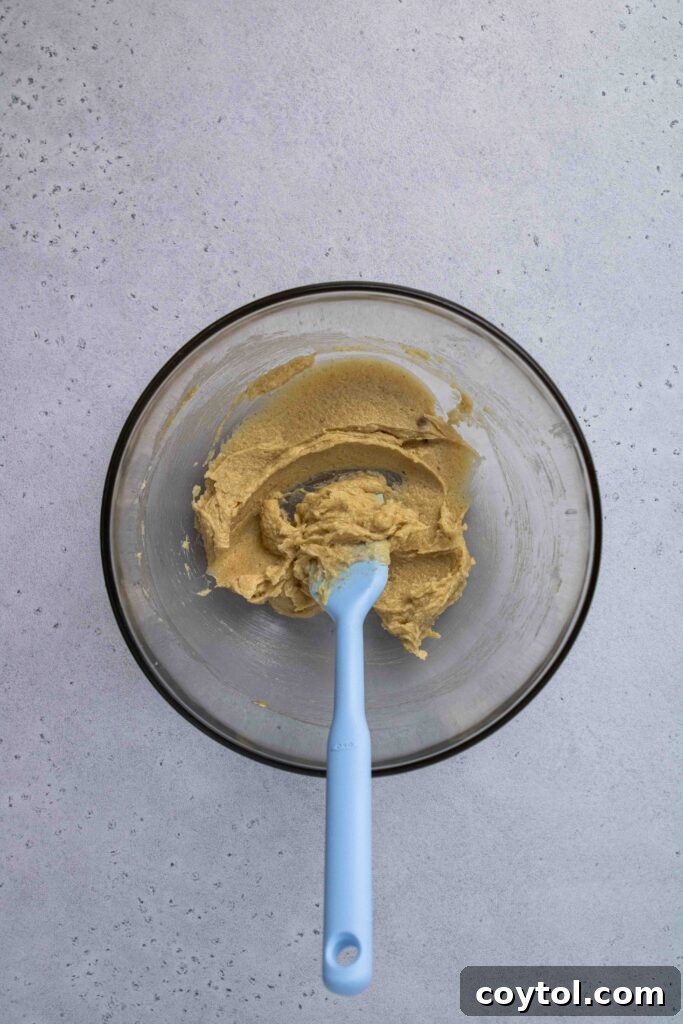The fully creamed butter, sugar, and egg yolk mixture, smooth and pale.