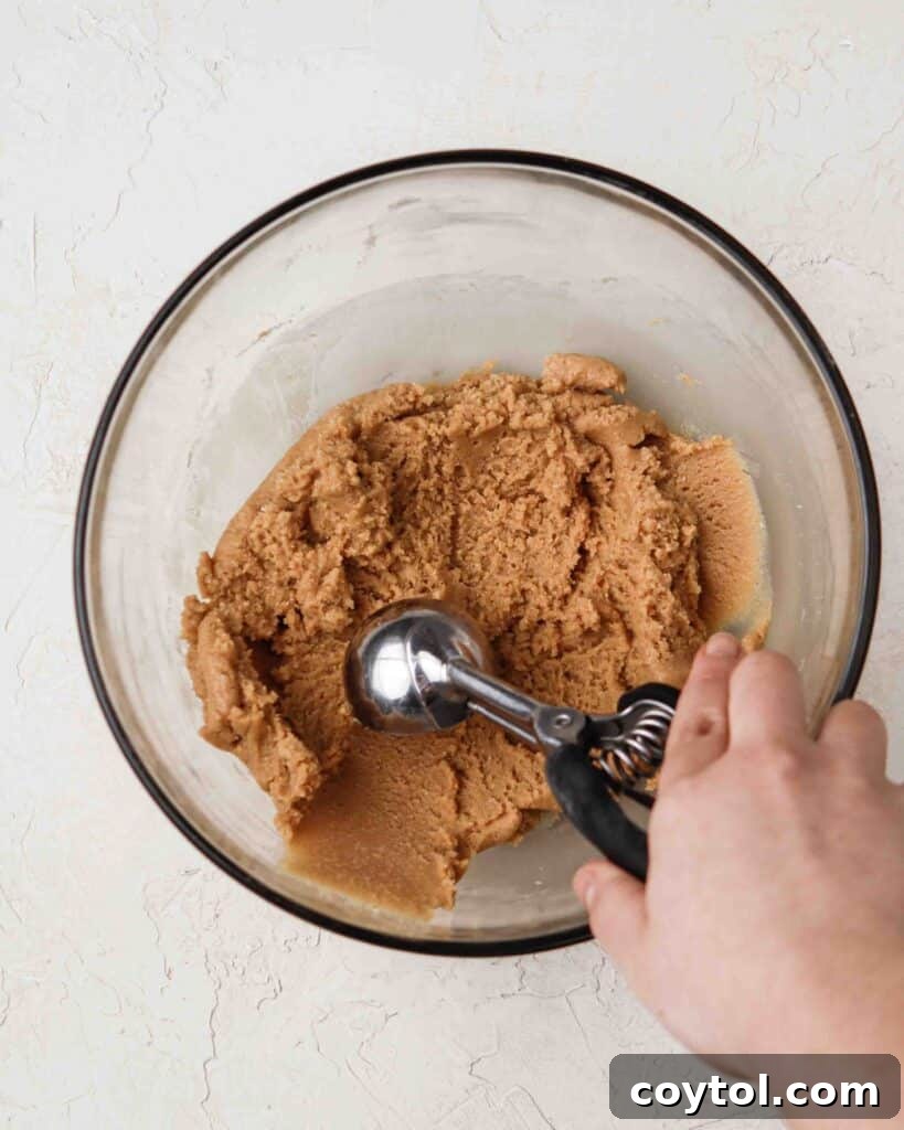 Pressing the no-bake 3-ingredient peanut butter cookies with a fork