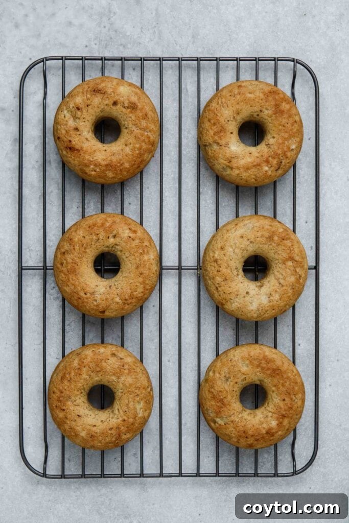 Baked donuts transferred to a cooling rack.