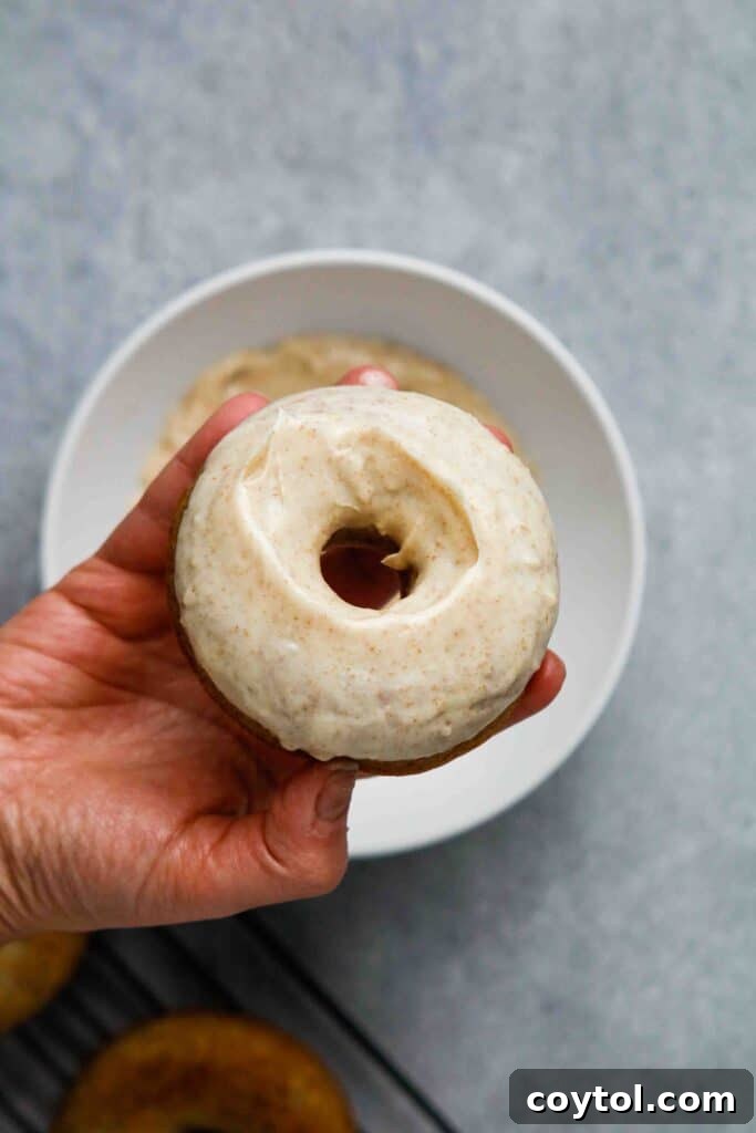 Close-up of a glazed banana donut, ready to eat.