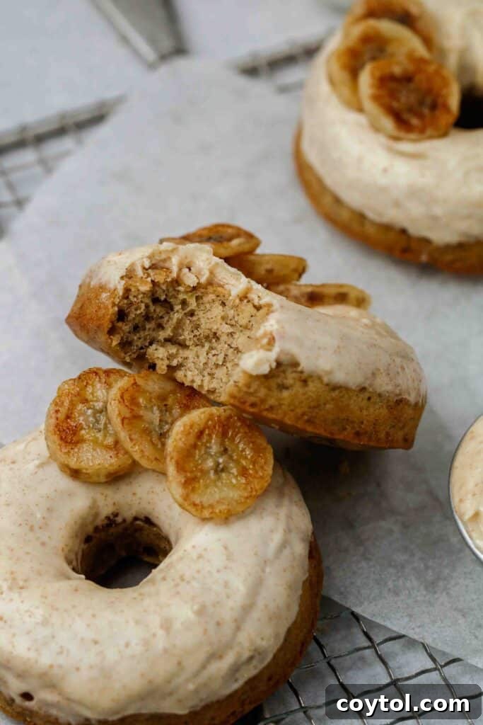 Close-up showing the soft, moist interior texture of a baked banana donut.