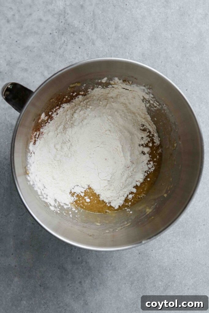Donut pan with cavities filled with banana donut batter.