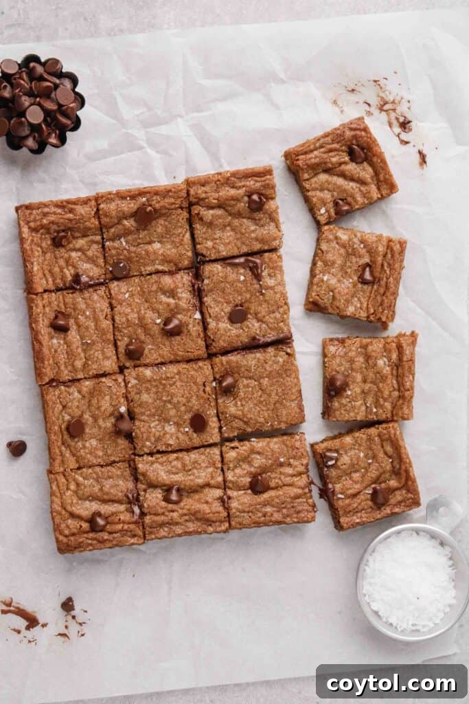 An overhead shot showcasing freshly baked chocolate chip cookie bars, cut into neat squares