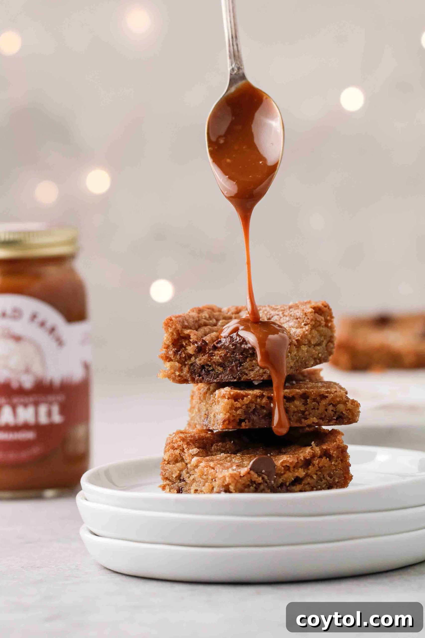 A neatly stacked pyramid of homemade chocolate chip cookie bars, showcasing their golden-brown edges