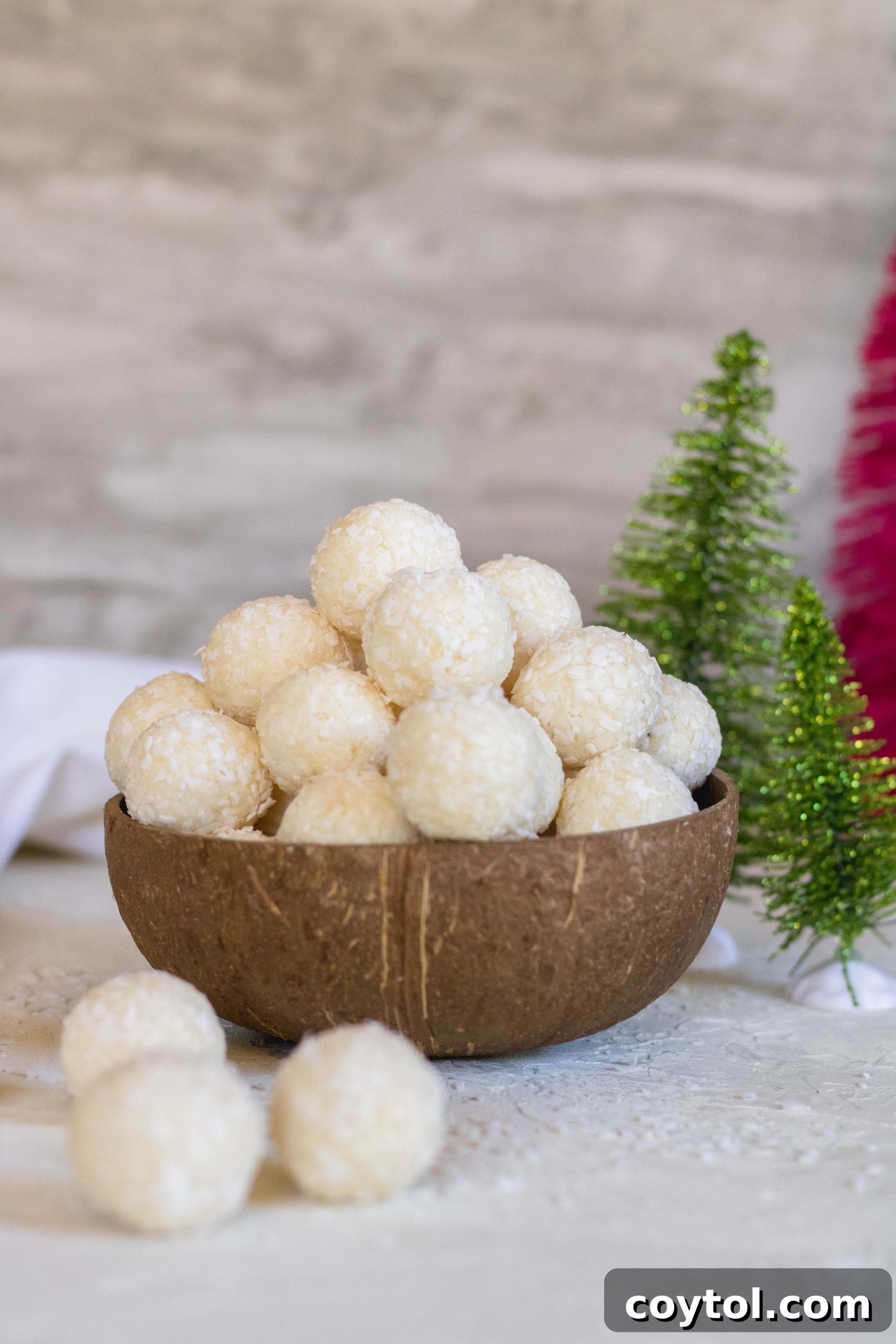 Delicious 2-ingredient coconut truffles in a coconut bowl, perfect for a quick and easy dessert.
