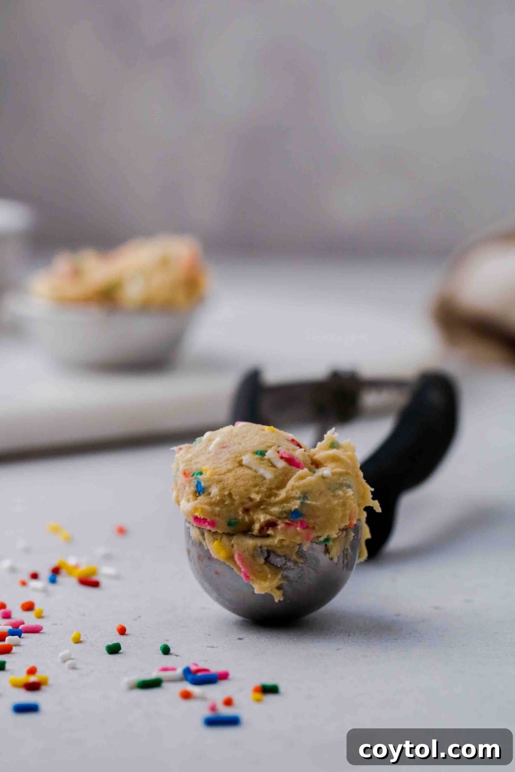 Ice cream scoop full of edible funfetti cookie dough for one