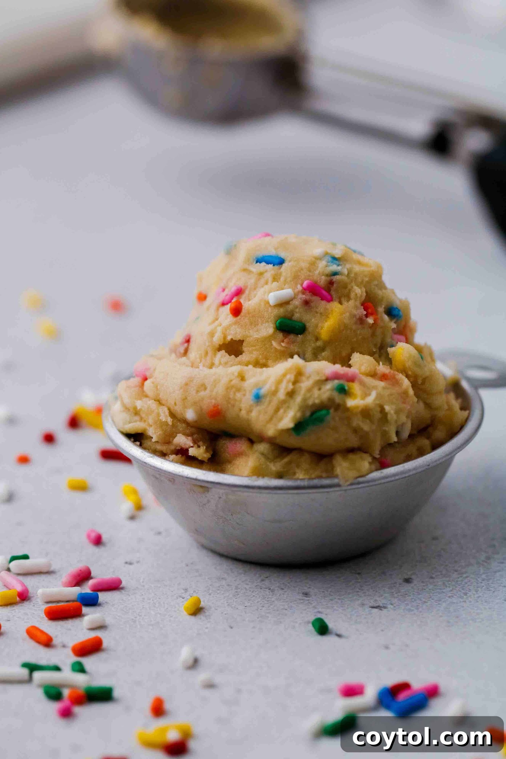 Edible funfetti cookie dough scooped on a plate
