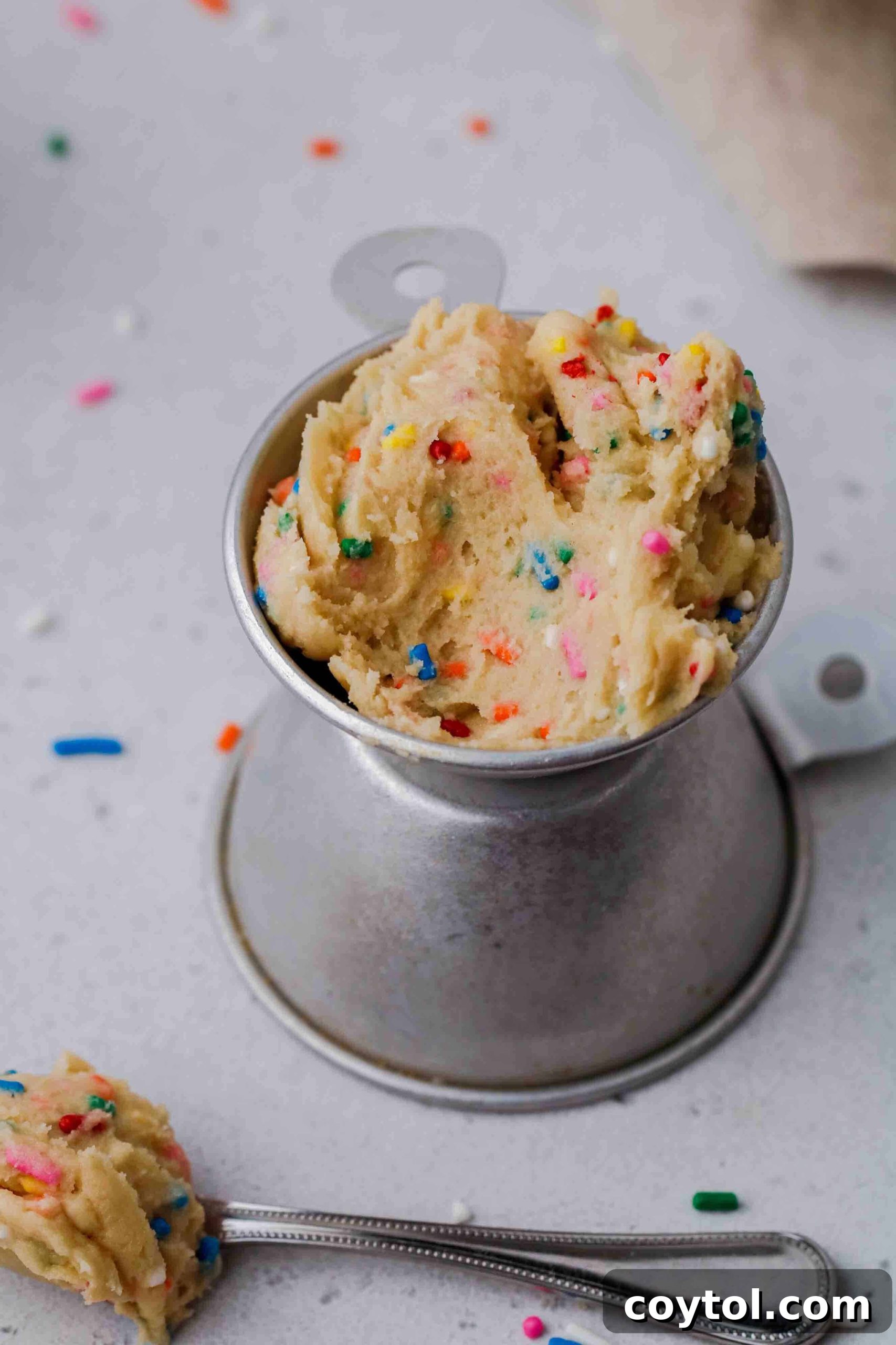 Close-up of a spoonful of creamy edible cookie dough