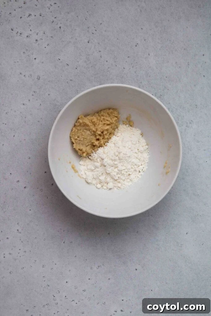 Mixing flour into the butter mixture for edible cookie dough